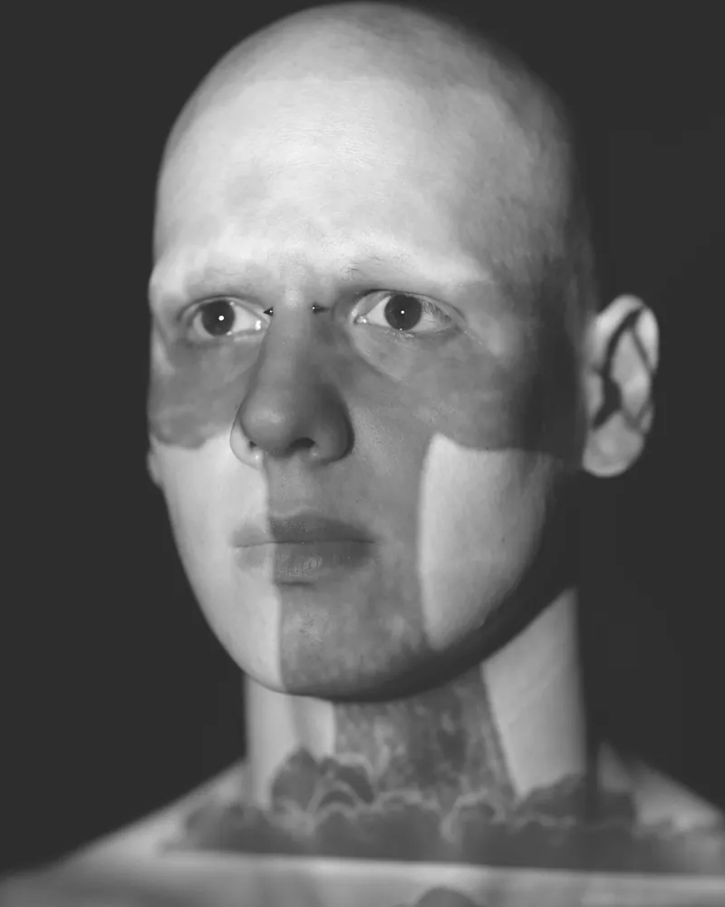 Sample plate — a close portrait held in shadow, treated monochrome