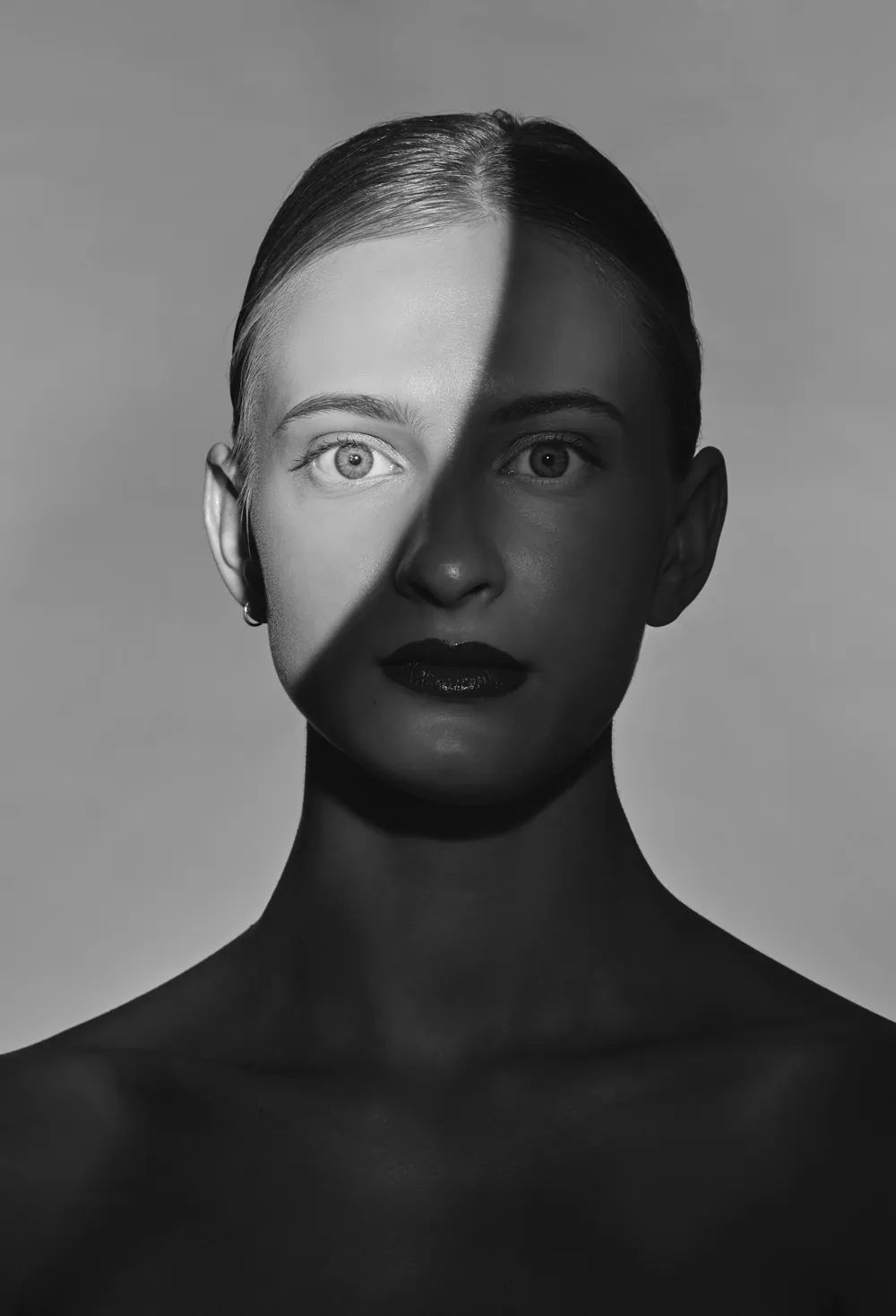 Sample series still — a shadowed studio portrait, treated monochrome