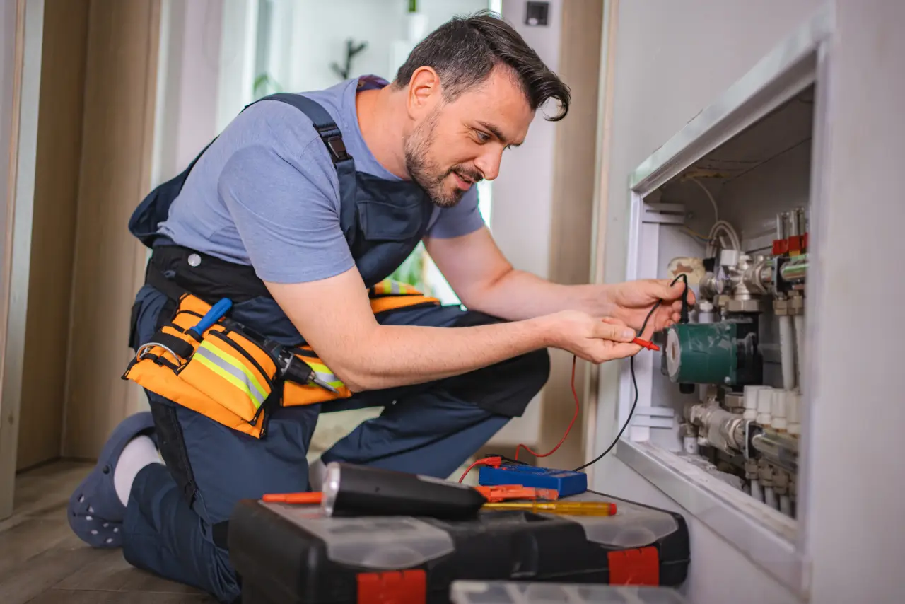 A technician servicing a water heater on a San Diego job site.